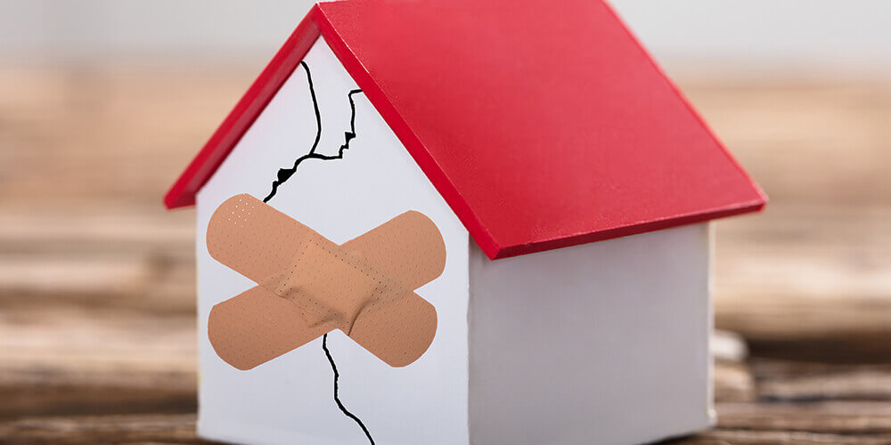 Broken house represent that little debt can be leverage, but if too much, it crushes. 